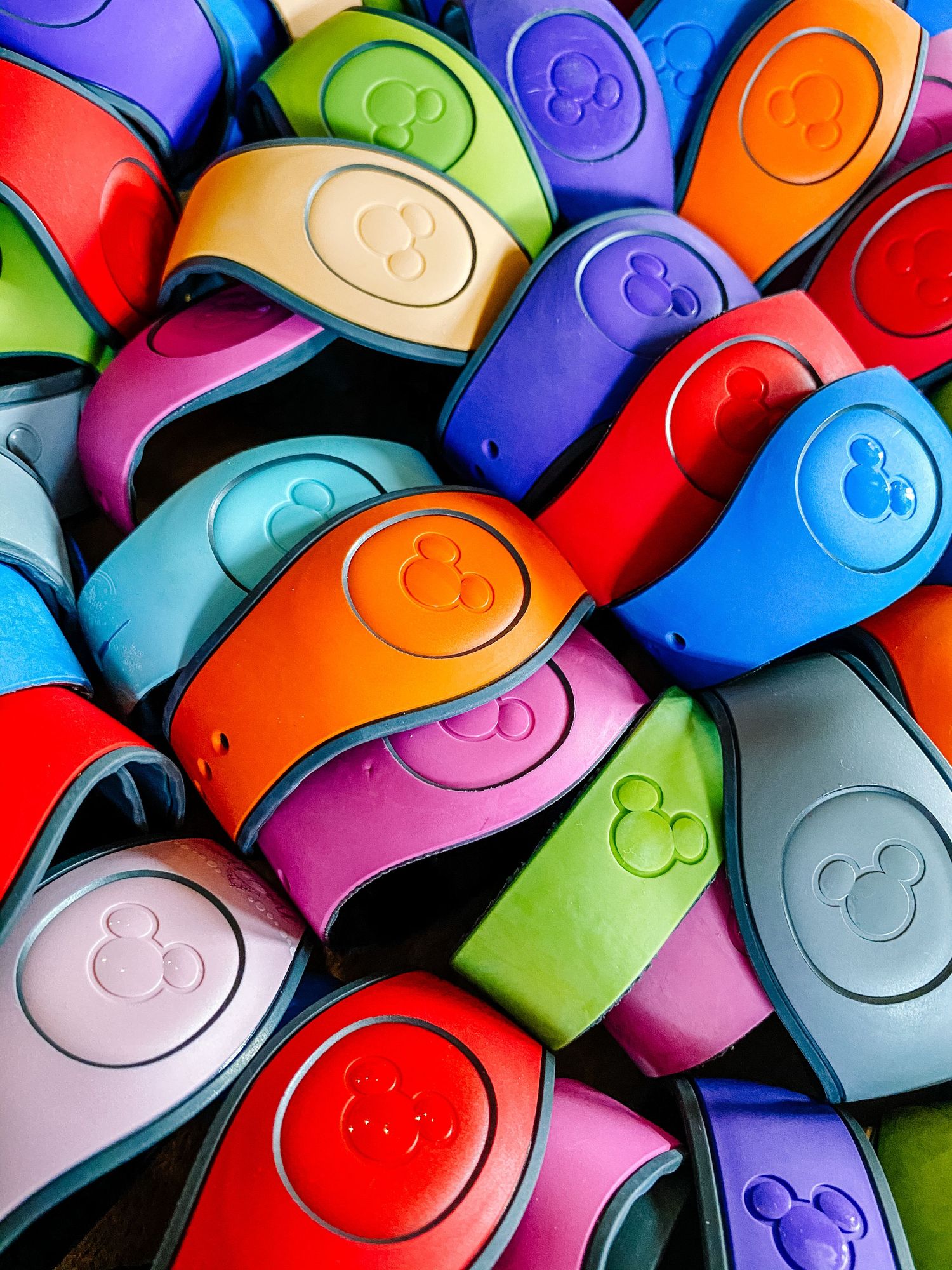 Colorful collection of acrylic markers arranged in a diagonal pattern showing smiley face logos on their caps.