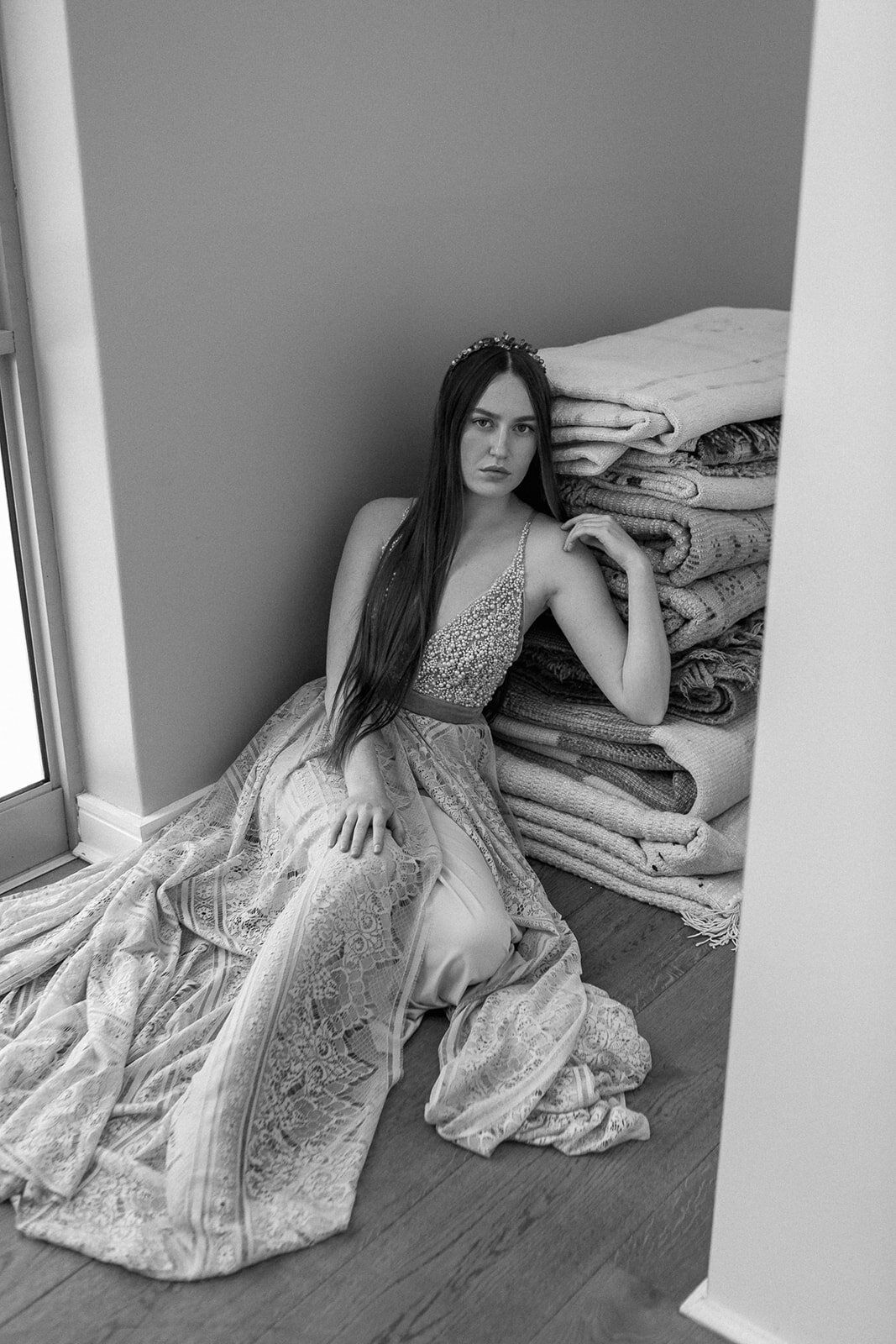 Wearing a Silver Swallow Design beaded dress Philipa leans against a pile of antique moroccan carpets.