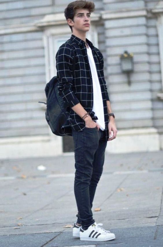 Urban street style with black plaid shirt, backpack and Adidas sneakers.