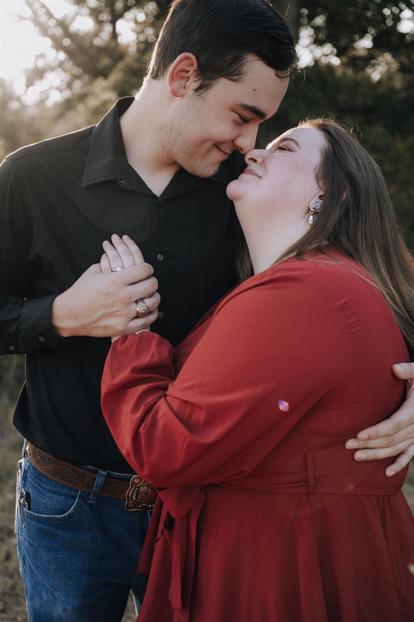 A loving couple shares an intimate moment during their engagement photoshoot in nature.