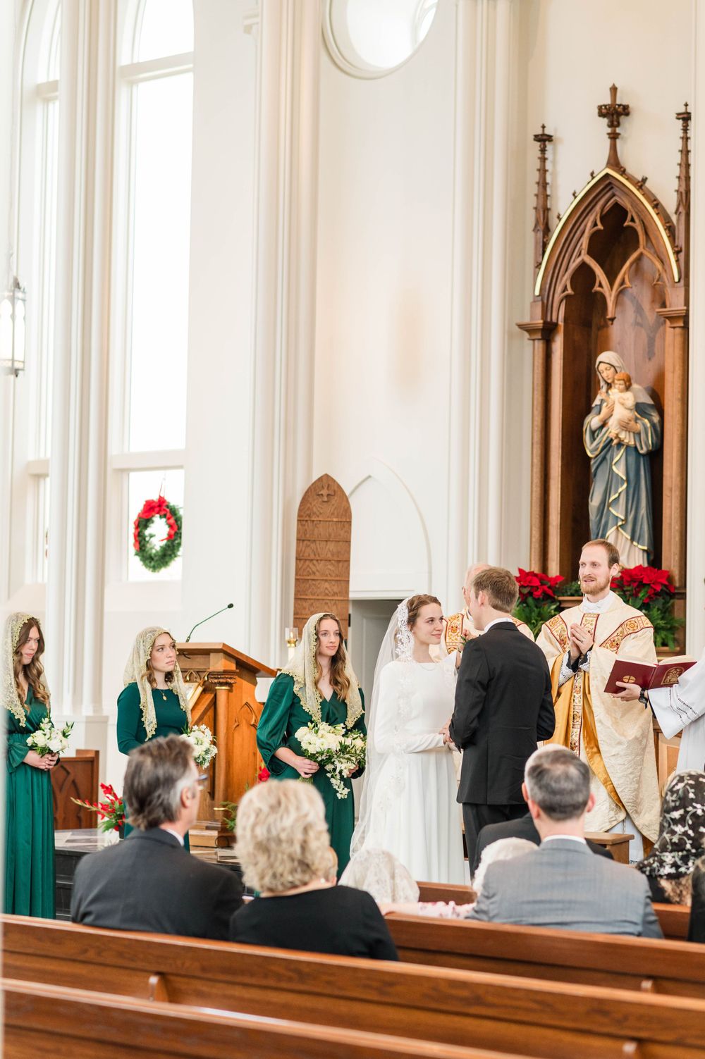 Husband and wife praying during their wedding mass at St. Francis Xavier in Stillwater, Oklahoma.