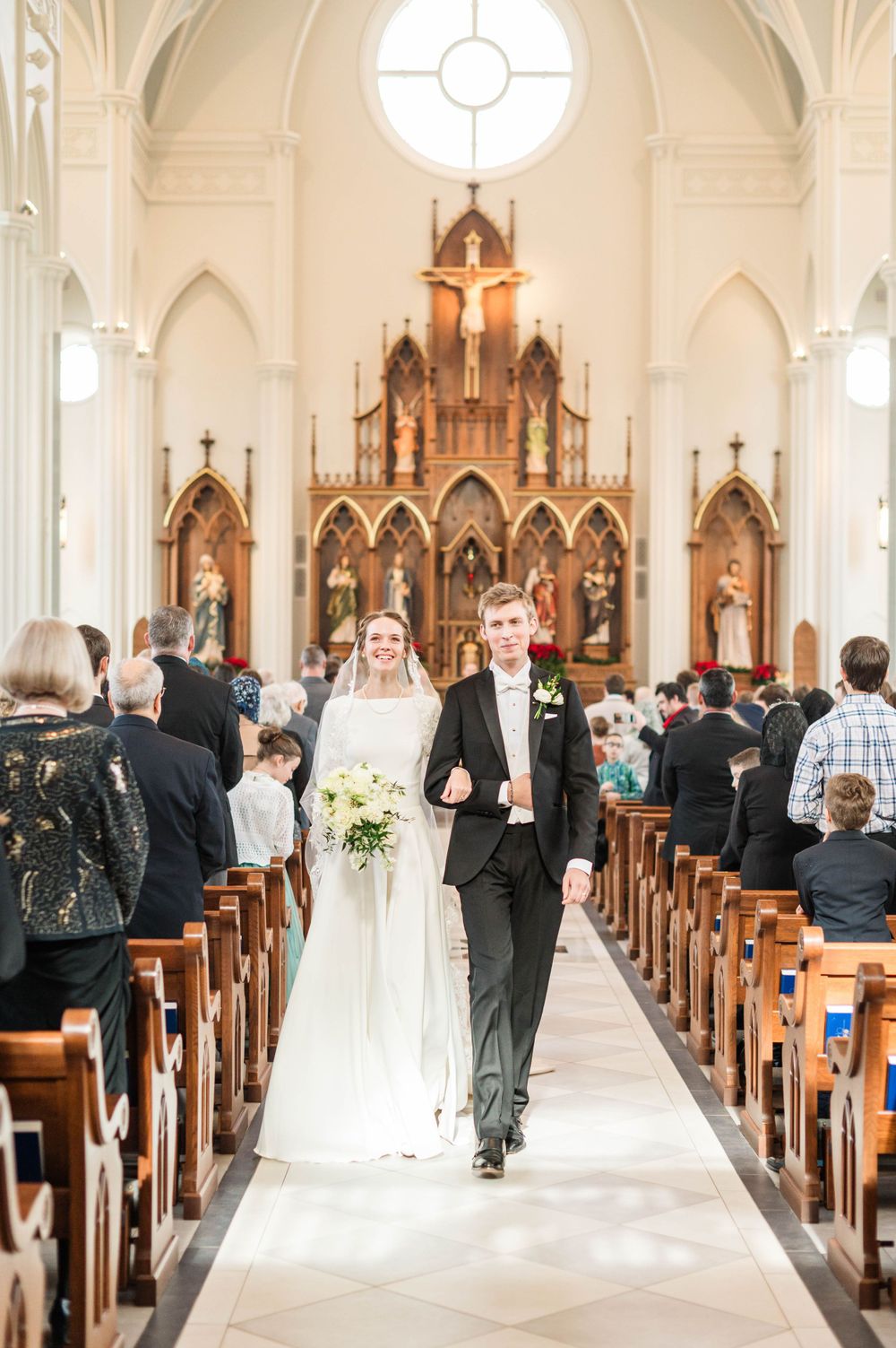 Husband and wife praying during their wedding mass at St. Francis Xavier in Stillwater, Oklahoma.