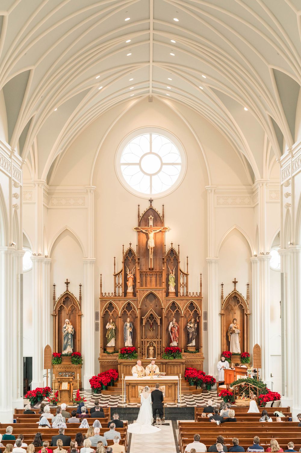 Husband and wife praying during their wedding mass at St. Francis Xavier in Stillwater, Oklahoma.