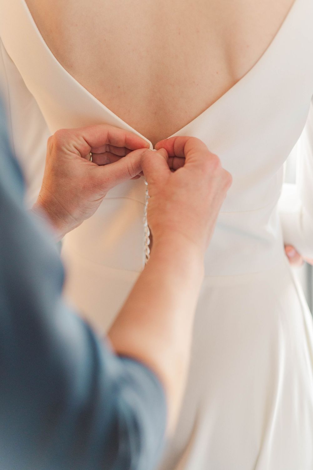Bride gets ready at Meditations Event Center in Stillwater, Oklahoma ahead of her catholic wedding at St. Francis Xavier in Stillwater, OK.