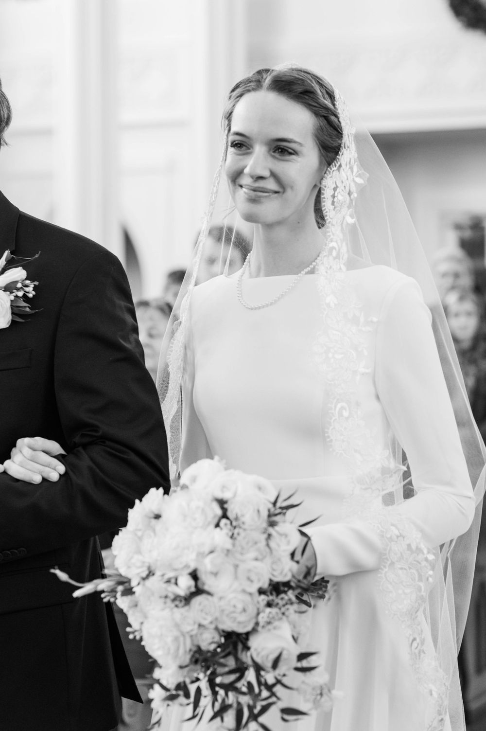 Bride walking down the aisle during her wedding mass at St. Francis Xavier in Stillwater, Oklahoma.