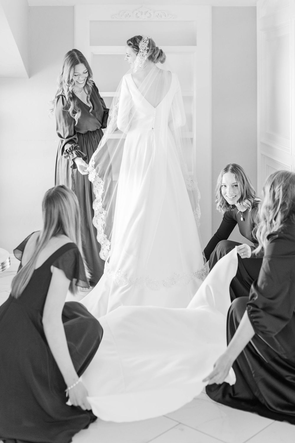 Bride gets ready at Meditations Event Center in Stillwater, Oklahoma ahead of her catholic wedding at St. Francis Xavier in Stillwater, OK.