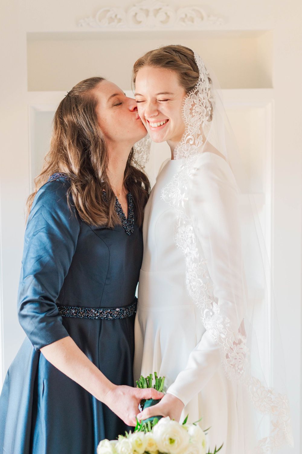 Bride gets ready at Meditations Event Center in Stillwater, Oklahoma ahead of her catholic wedding at St. Francis Xavier in Stillwater, OK.