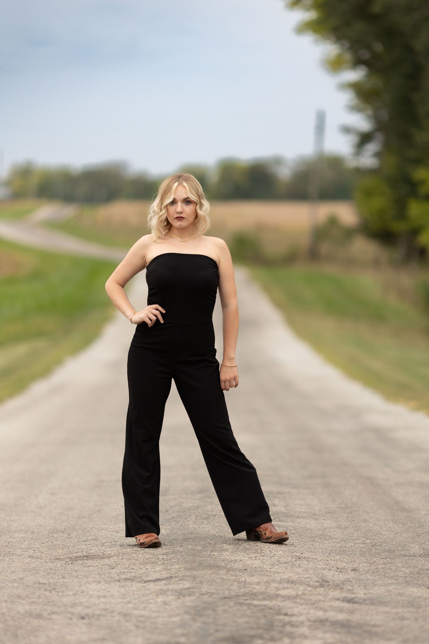 High school senior strikes fierce pose on a country road outside of Mattoon, Illinois.