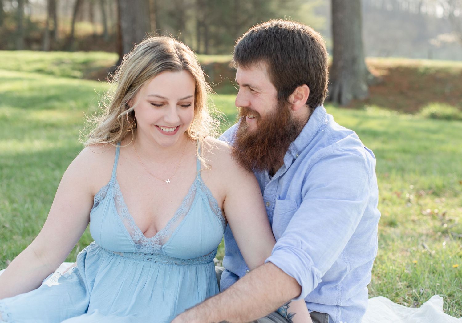 A couple enjoying a romantic afternoon picnic on a sunny day in the park.