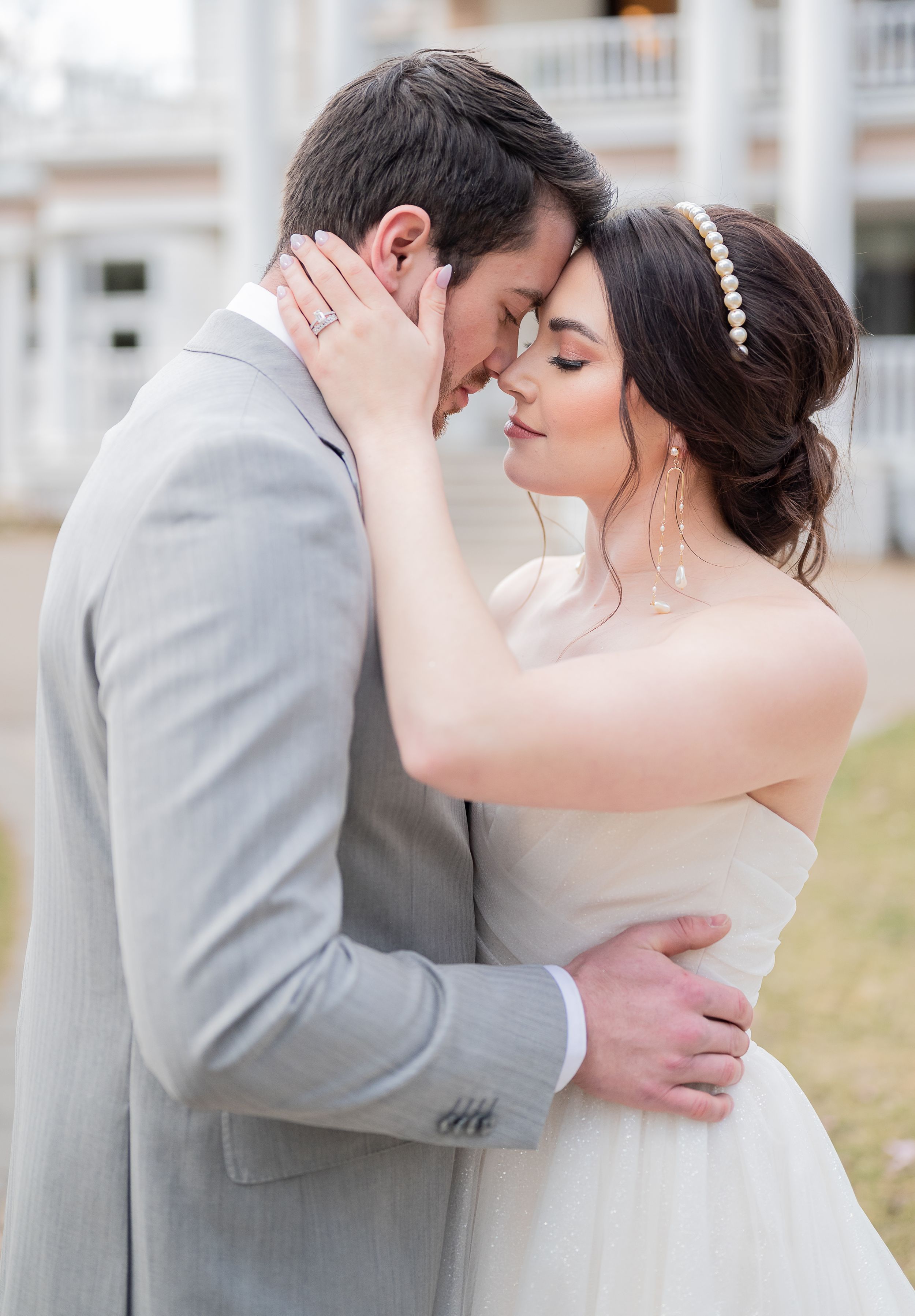 Sweet wedding couple embracing in series of romantic poses outdoors.