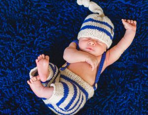 newborn boy pose natural light photography studio session crochet outfit custom creative set memory captured Alabama Baldwin county sleeping