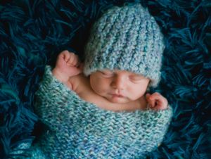 newborn boy pose natural light photography studio session crochet outfit custom creative set memory captured Alabama Baldwin county sleeping