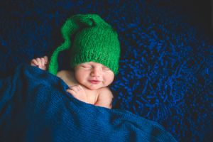 newborn boy pose natural light photography studio session crochet outfit custom creative set memory captured Alabama Baldwin county sleeping