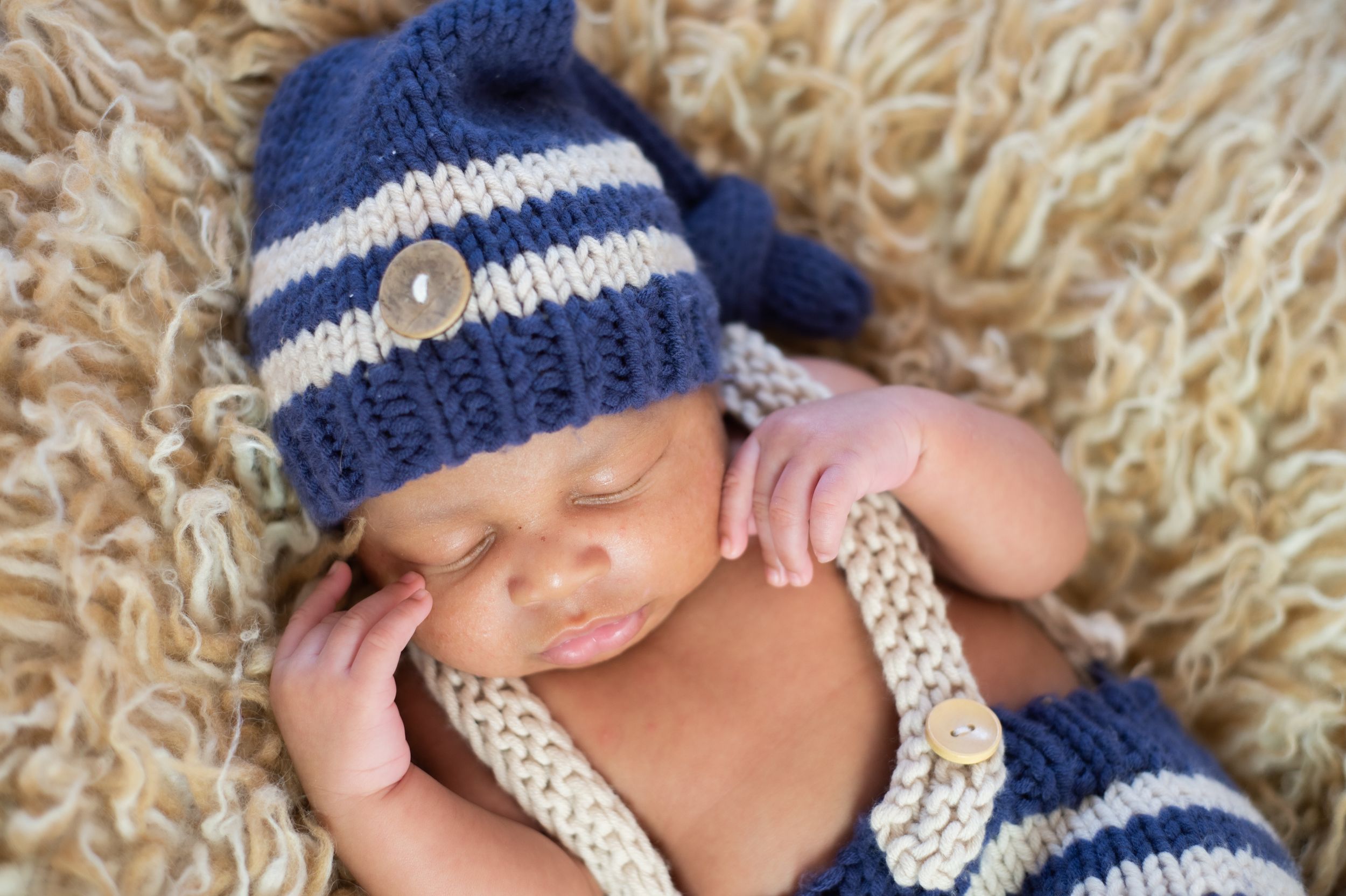 newborn boy pose natural light photography studio session crochet outfit custom creative set memory captured Alabama Baldwin county sleeping