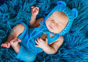 newborn boy pose natural light photography studio session knit outfit custom creative set memory captured Alabama Baldwin county sleeping