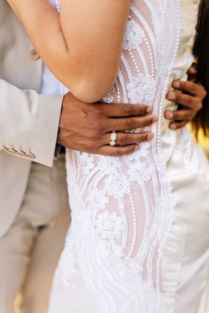 Close-up Tucson couples detail shot showing hands wrapped around the waist in an intimate, romantic moment.