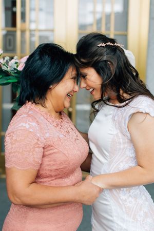 Tucson wedding day moment of a bride sharing an emotional forehead-to-forehead embrace with her mother.