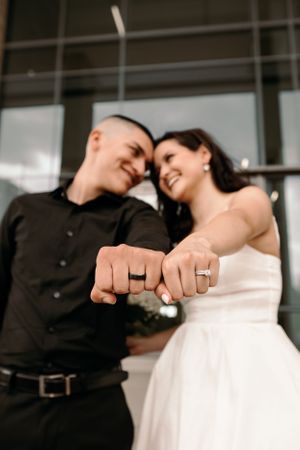 Modern Tucson wedding photo of a bride and groom popping champagne outside a contemporary venue.
