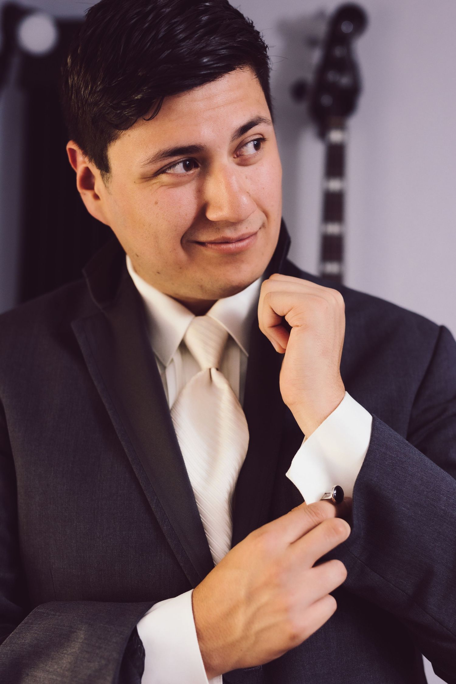 Groom buttoning his cuff