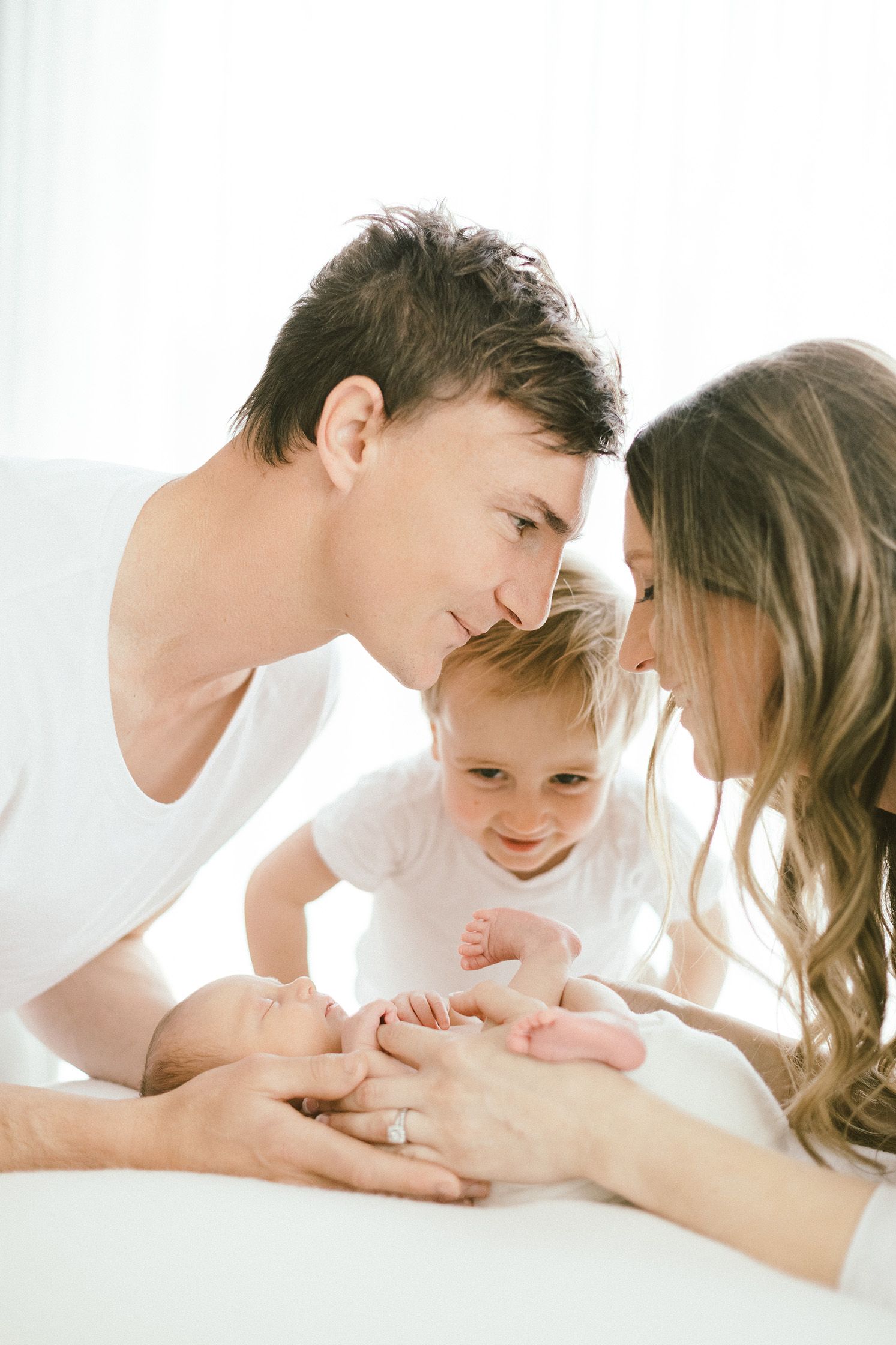 Happy family moment with parents and children sharing loving smiles.