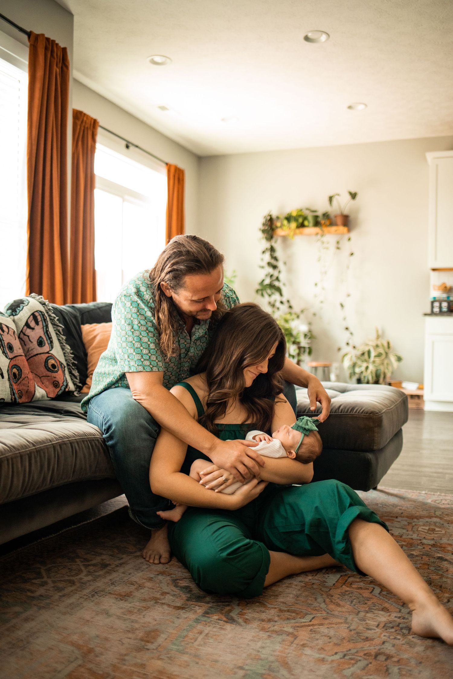 Mother and Father posing with their newborn baby in their Owensboro, Kentucky home.
