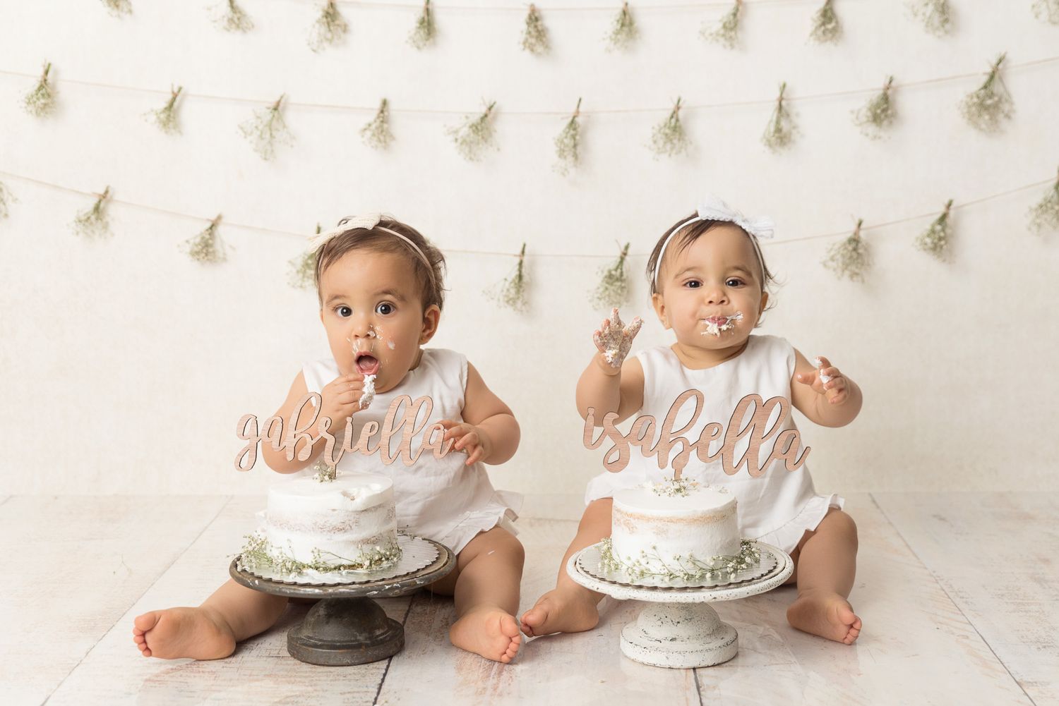 White cake smash photo setup with delicate string lights in the background.