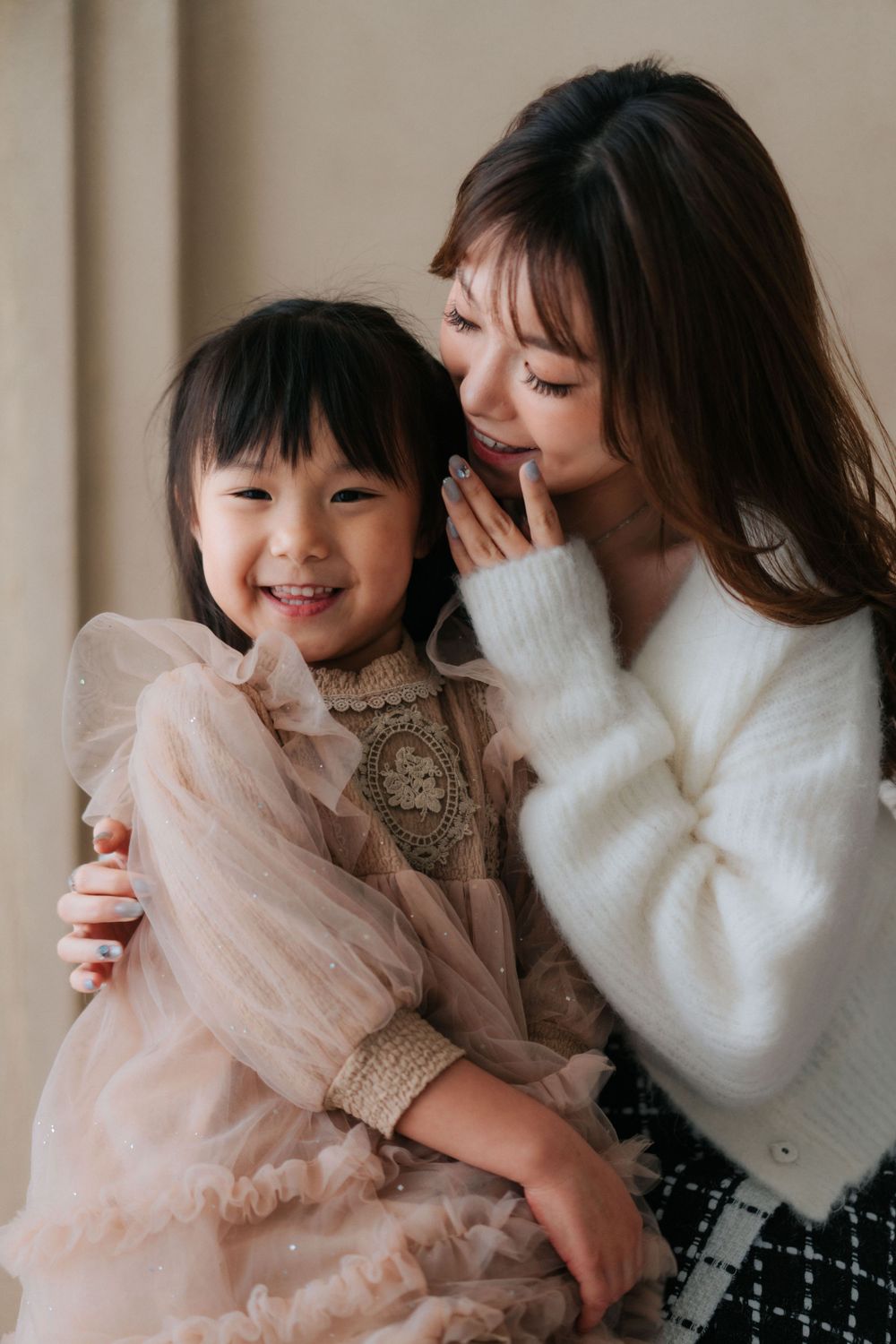 A tender moment captured in soft winter whites and delicate pink tulle.
