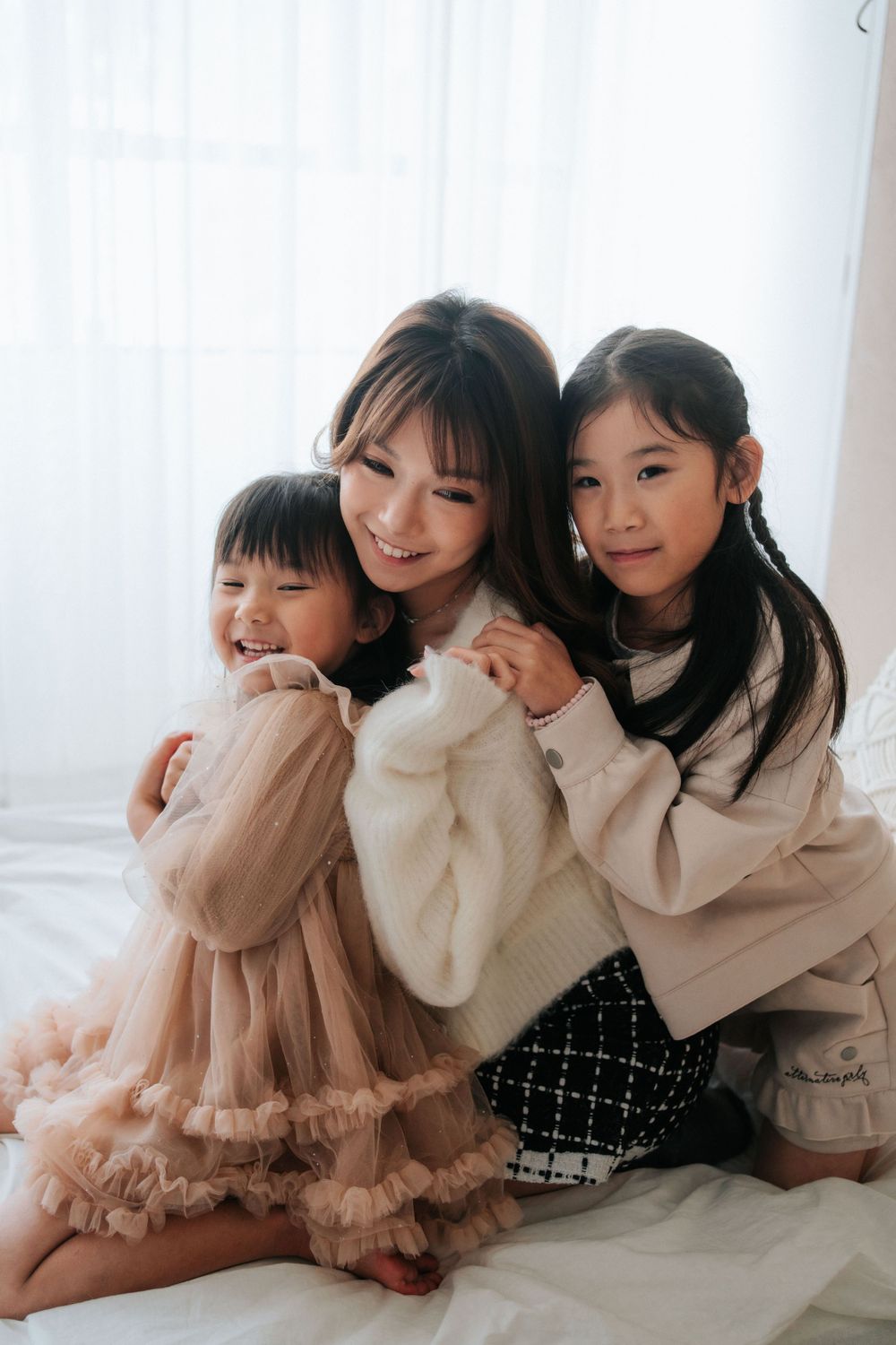 A joyful family moment captured in cozy sweaters and soft neutral tones.