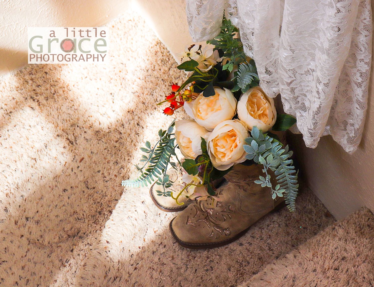 Wedding shoes with floral accents photographed against lace curtains and carpet.
