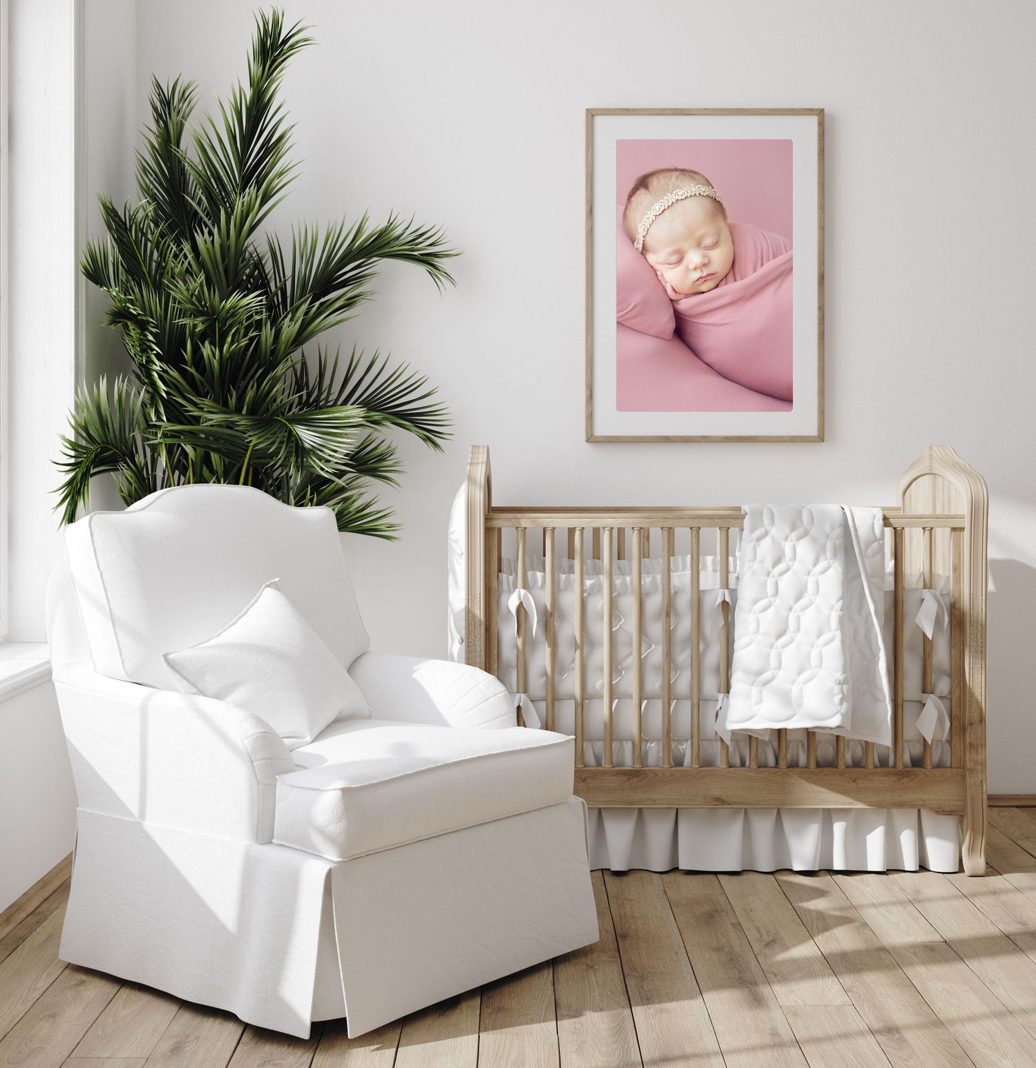 Newborn nursery with framed photo of sleeping newborn above the crib