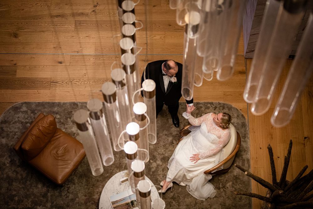 Overhead view of wedding couple surrounded by glowing cylindrical light installations.