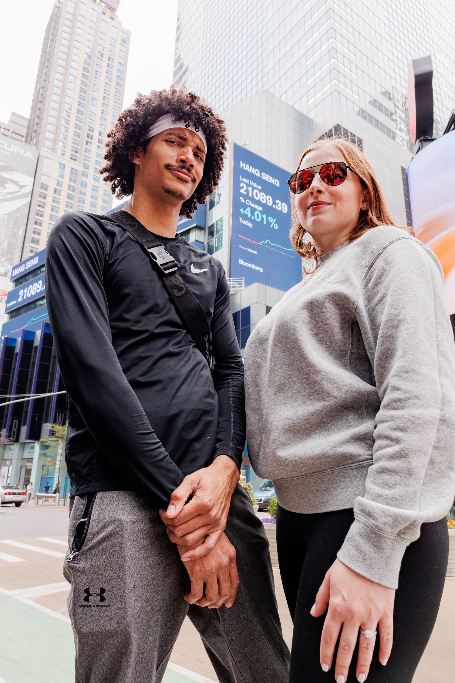 Urban engagement photos with city buildings and playful poses in casual wear.