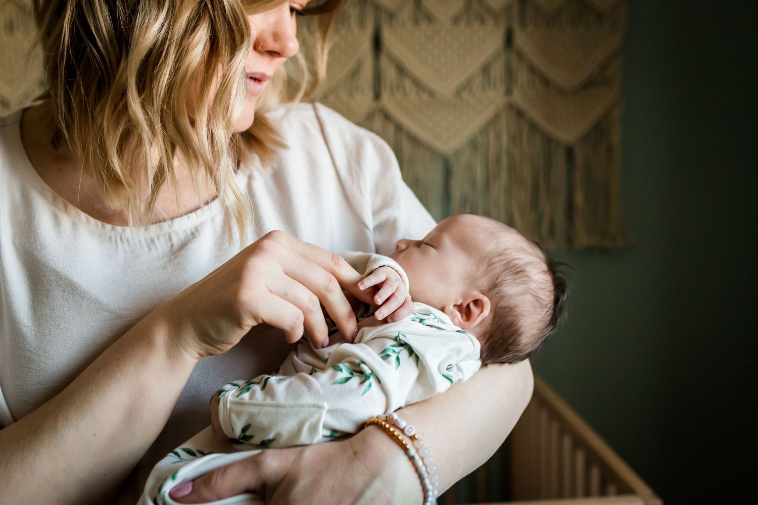 Lifestyle newborn photos at home, Calgary AB: Soft pinks, creams, sage green.
