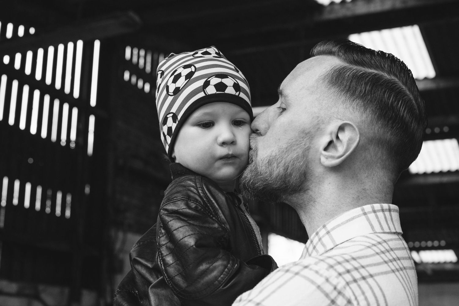 An intimate black and white portrait capturing a tender family moment.