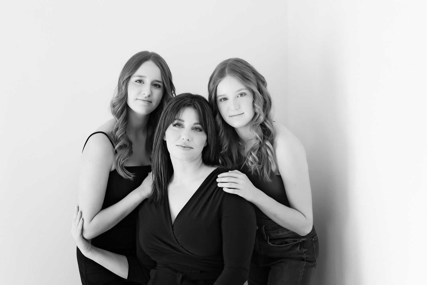 mom and daughters closely posed