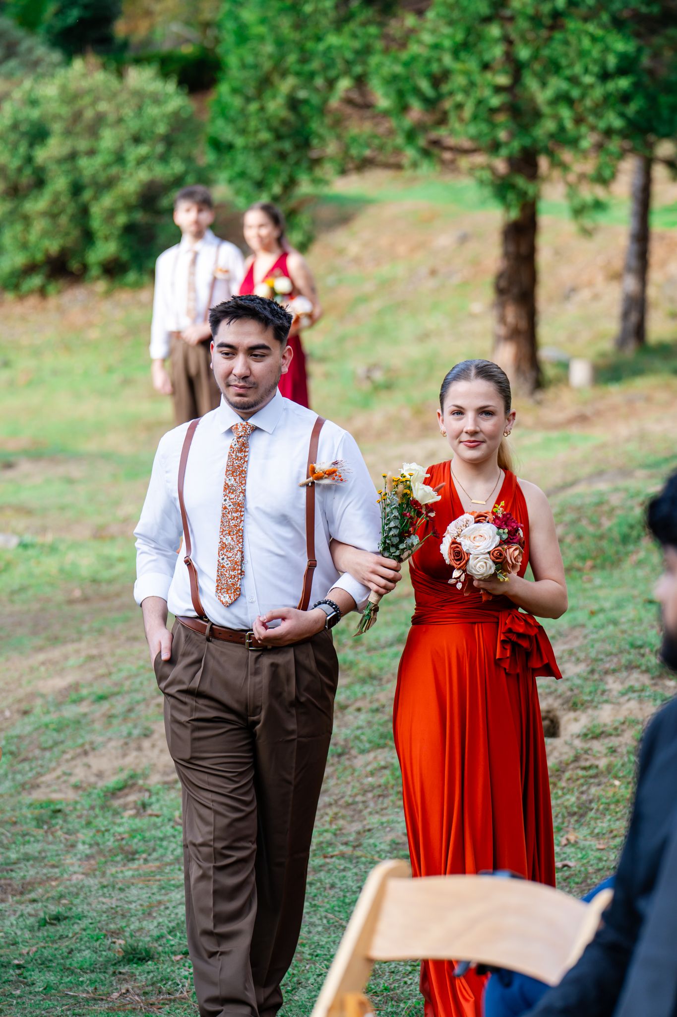 groomsman and bridesmaid in orange