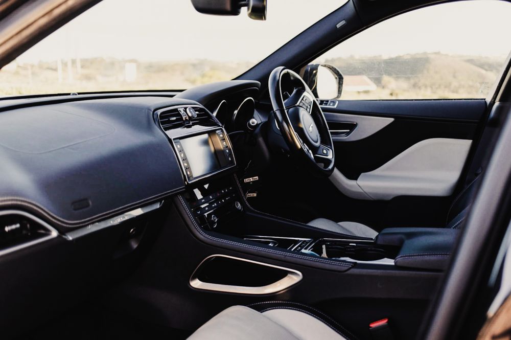 Interior dashboard view of a modern luxury car with right-hand drive configuration.