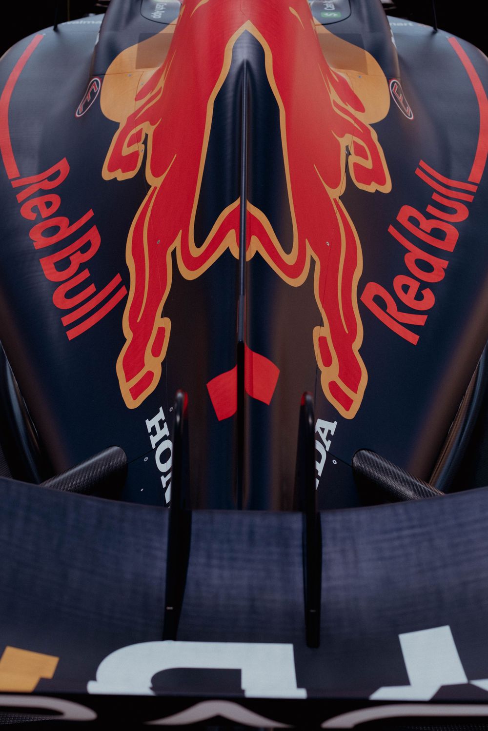 Overhead view of Red Bull Formula 1 car nose showing detailed red bull logo design on navy blue paint.