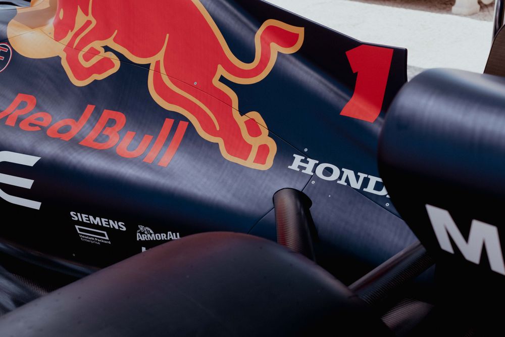Detail shot of Red Bull Honda Formula 1 car bodywork showing sponsors and iconic red bull logo.
