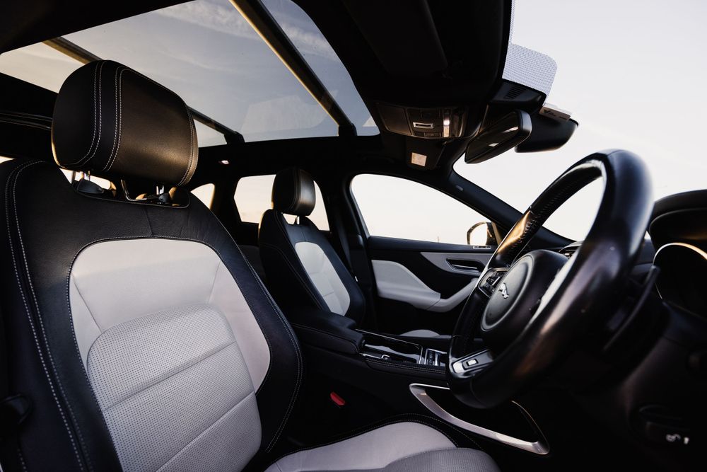 Interior view of a premium vehicle showing leather seats and modern dashboard design.