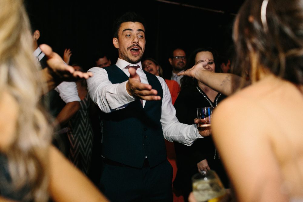 Energetic dancing and celebration during evening wedding reception.