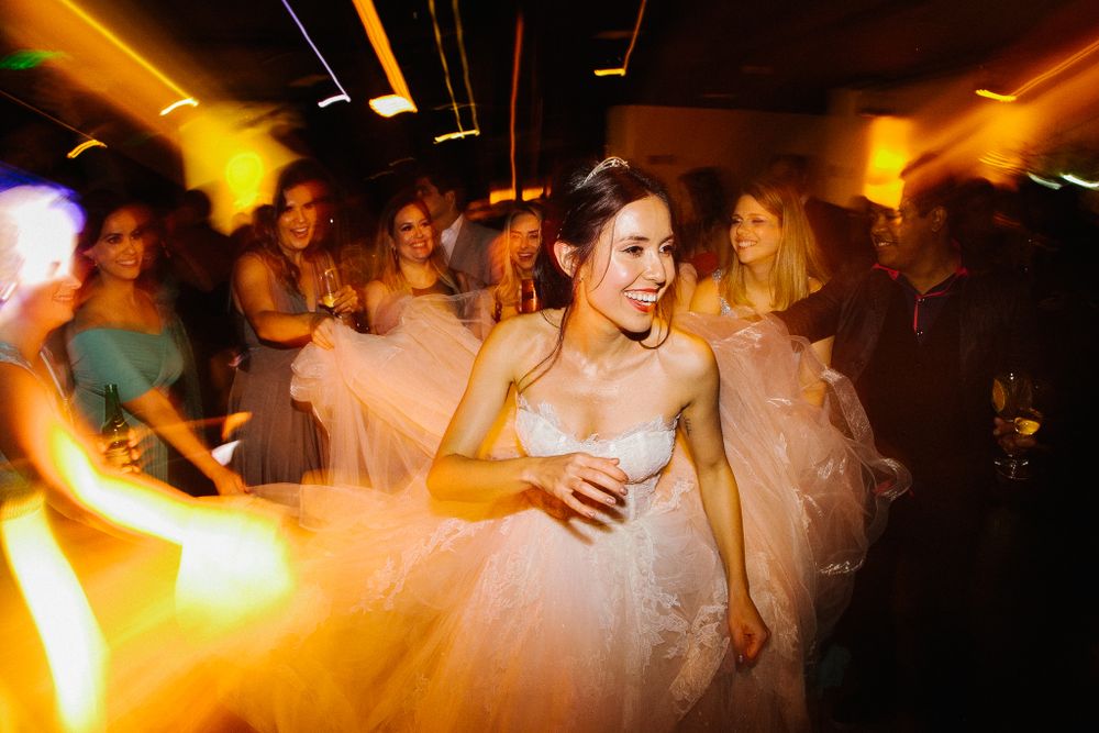 Wedding reception party scene with dancing and amber lighting effects.