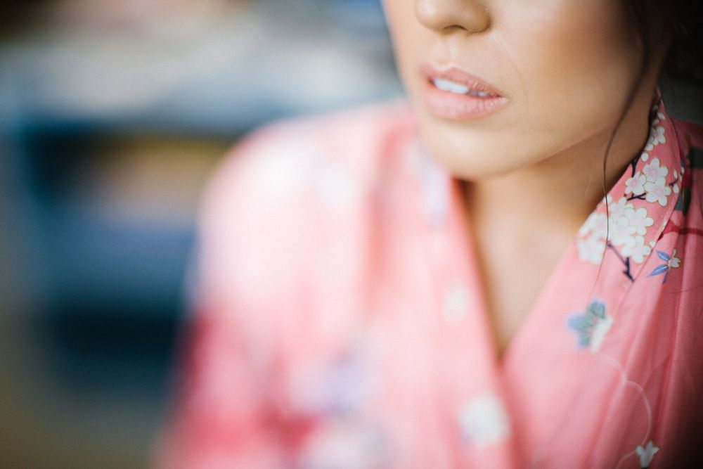 A soft focus portrait showing someone wearing a pink floral robe.