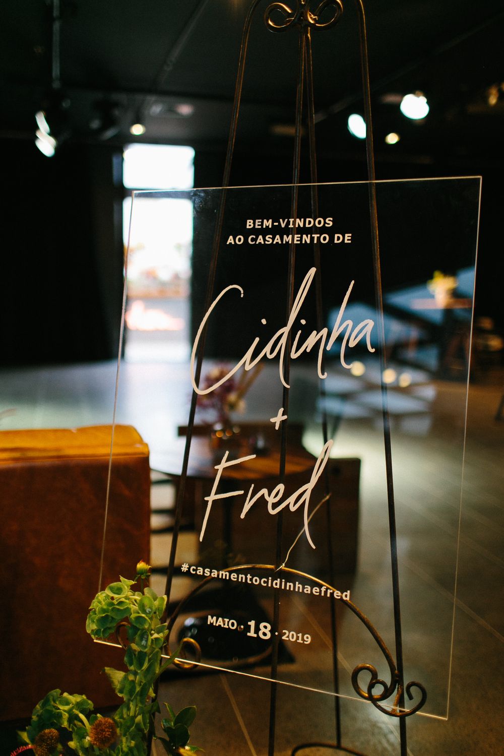 Acrylic welcome sign for a wedding featuring elegant script lettering and date.