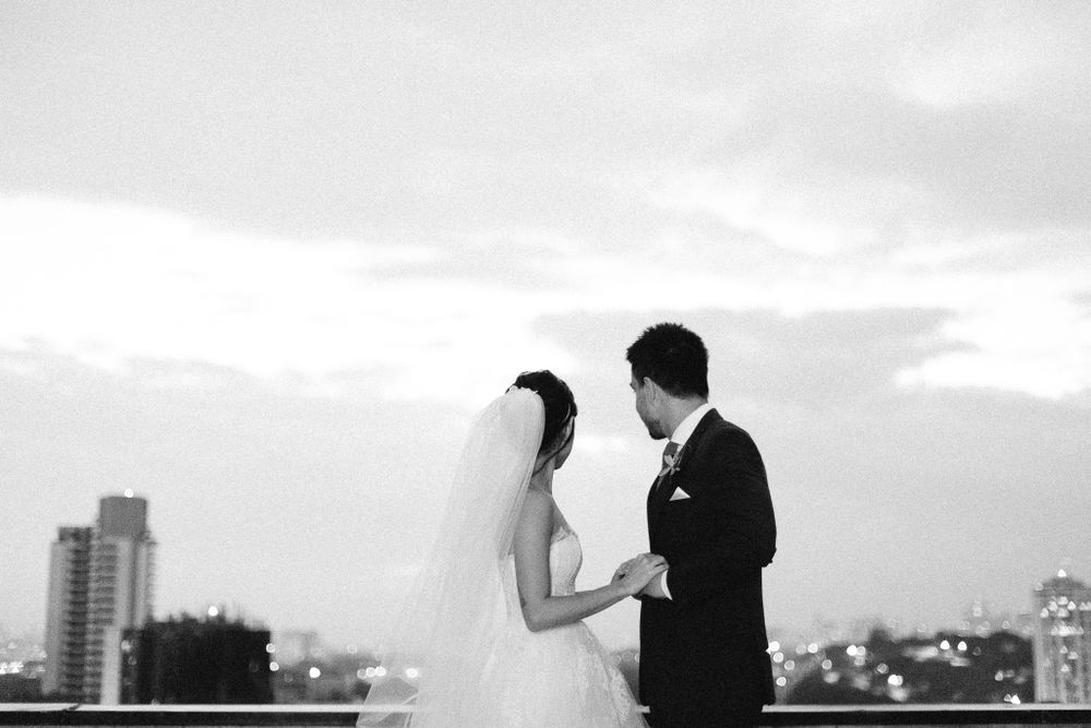 Black and white silhouette of couple against city skyline at dusk.