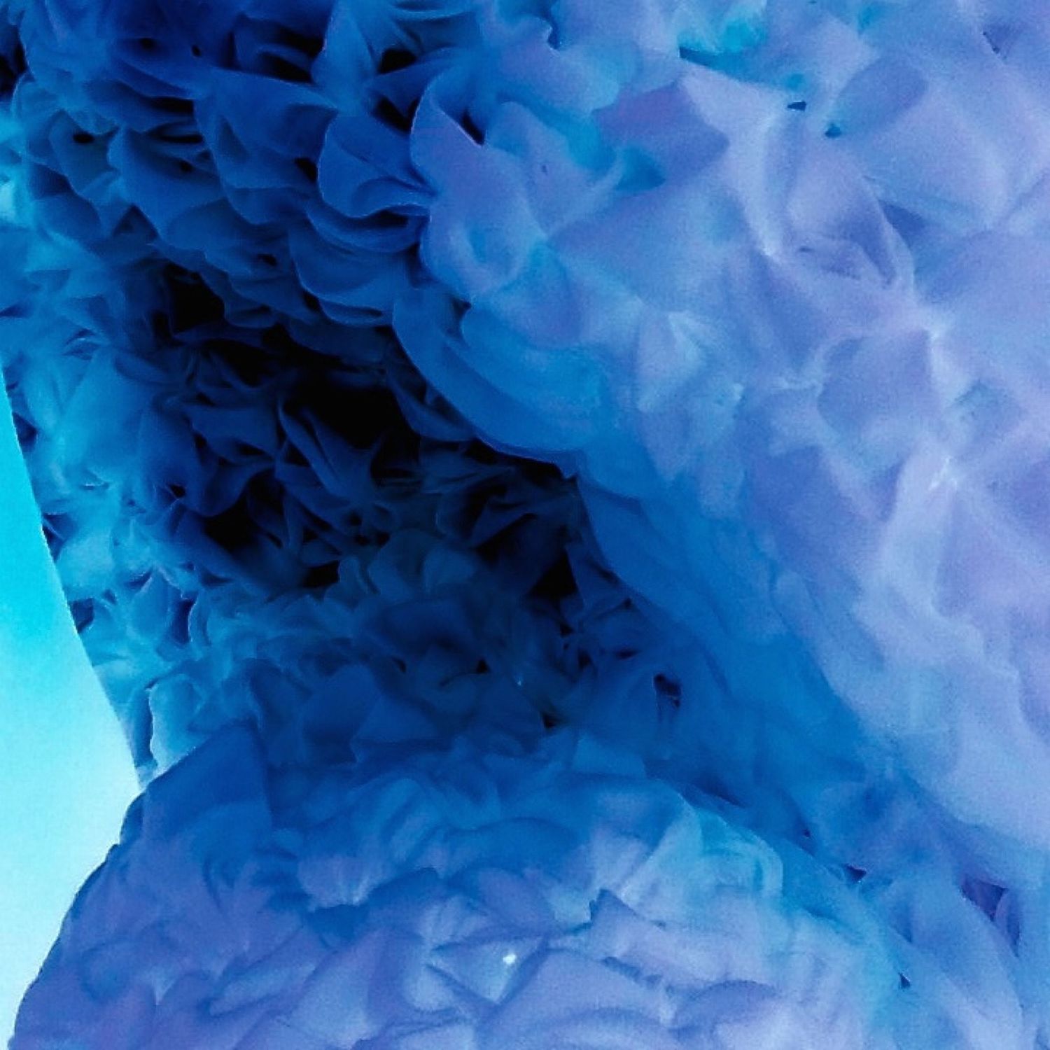Ethereal blue and purple ice formations creating a softly textured abstract pattern.