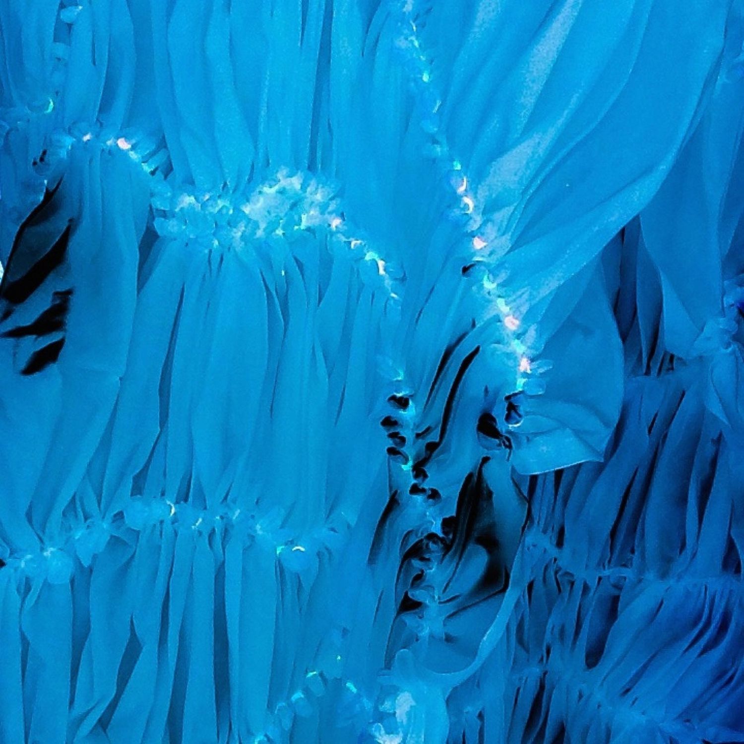 Ice cave interior showing flowing blue formations with crystalline textures.