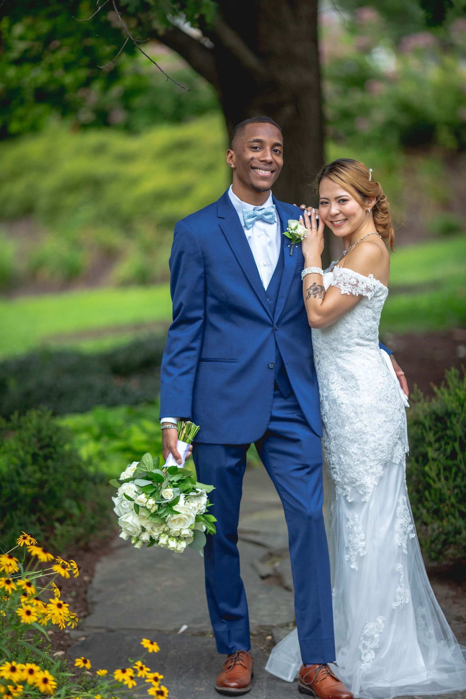 Married_couple_standing_together_with _bride_leaning_on_groom_shoulder
