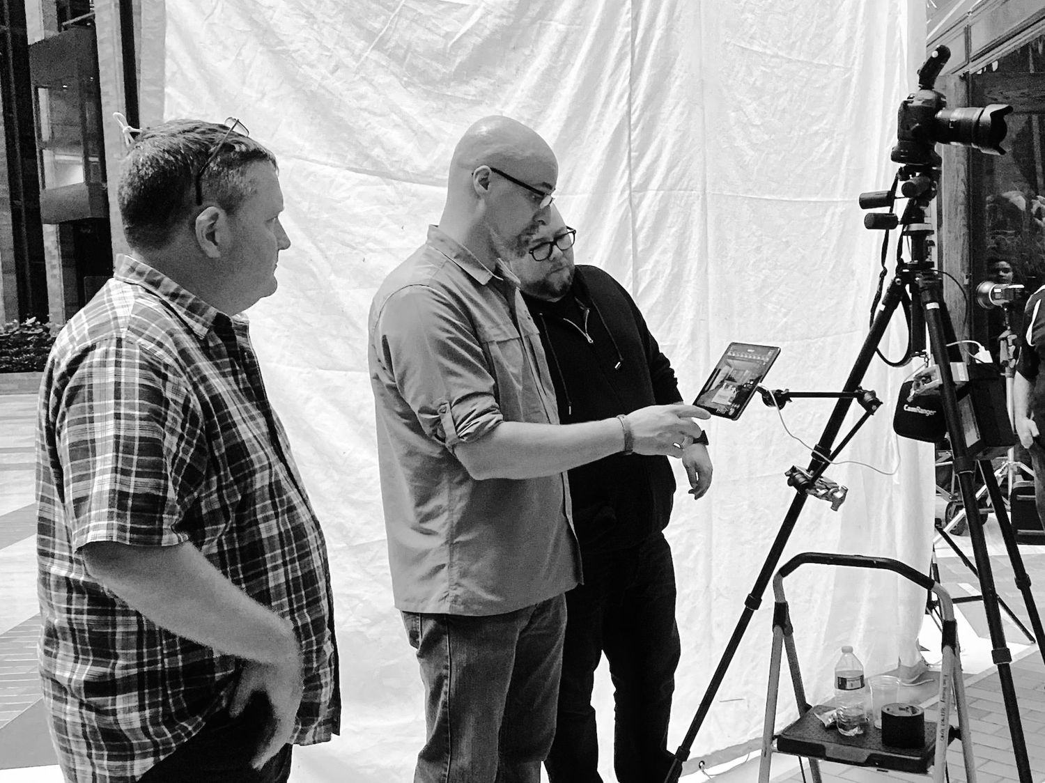 Behind the scenes photo shoot setup with camera equipment and backdrop.