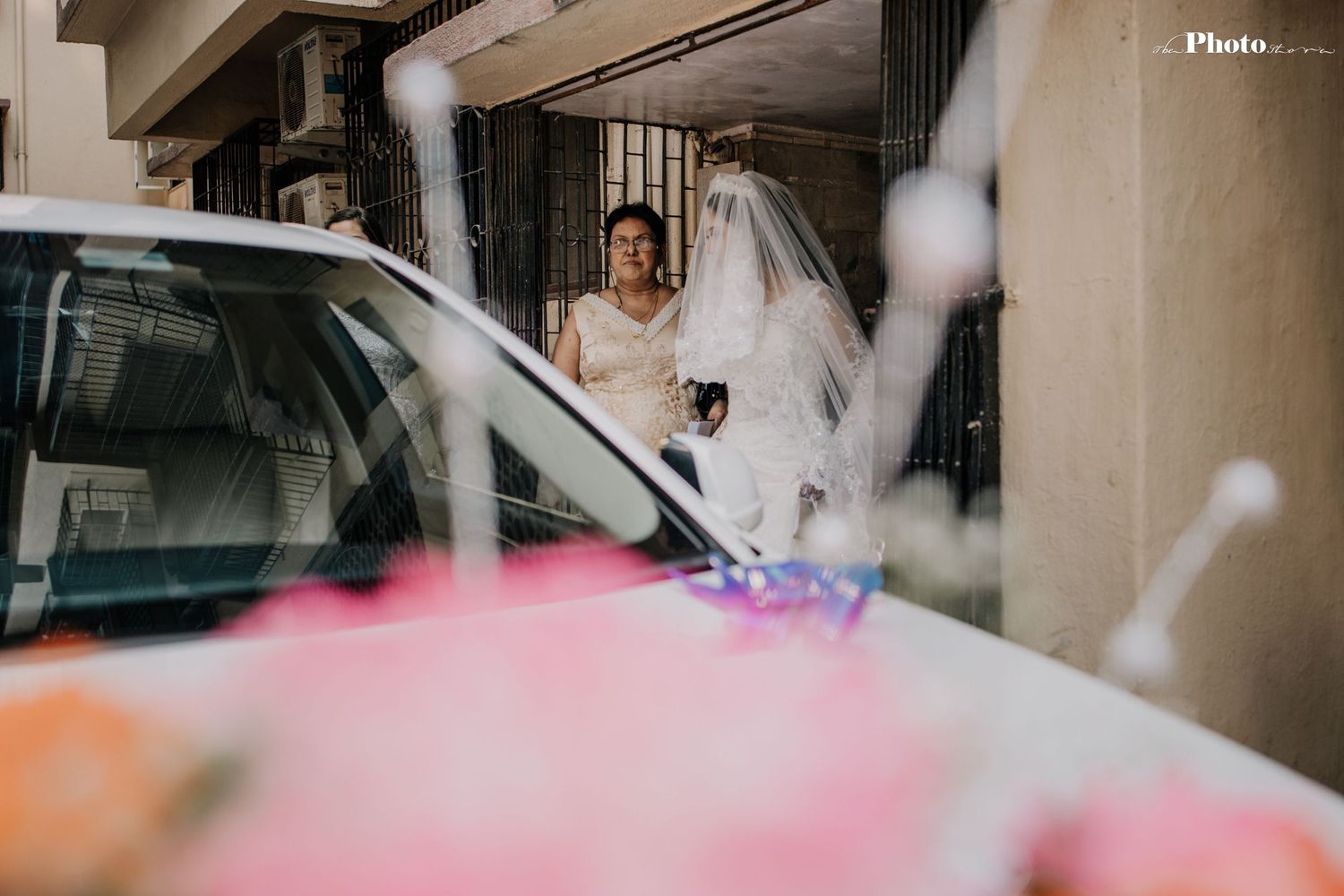 Motion blur photograph of wedding party walking through building corridor.